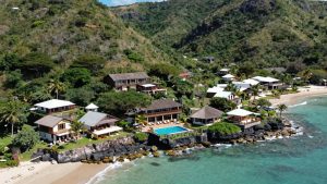 Nova Pousada Golfinho resort overlooking a turquoise bay.