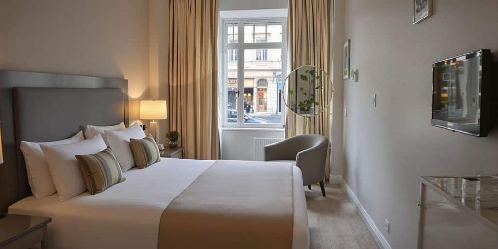 Cozy hotel room with inviting bed and natural light.