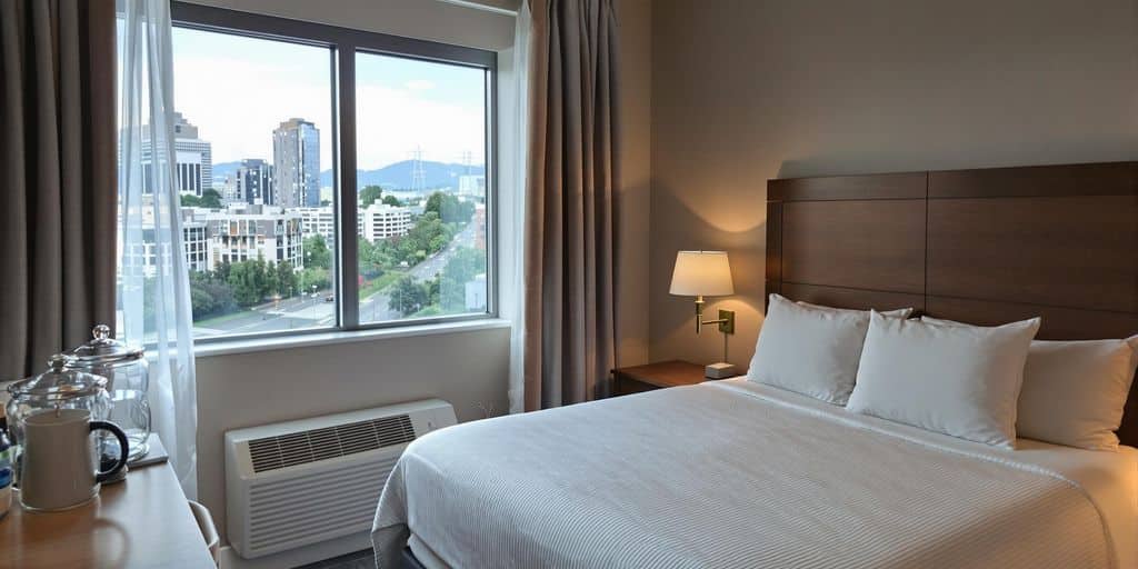 Budget hotel room with cozy decor and city view.