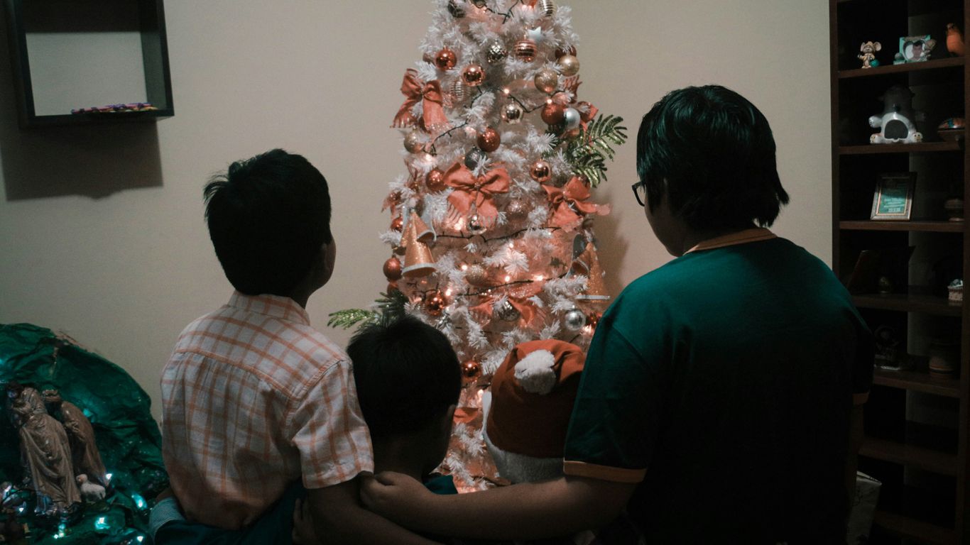 man in black shirt standing beside man in white and red plaid shirt