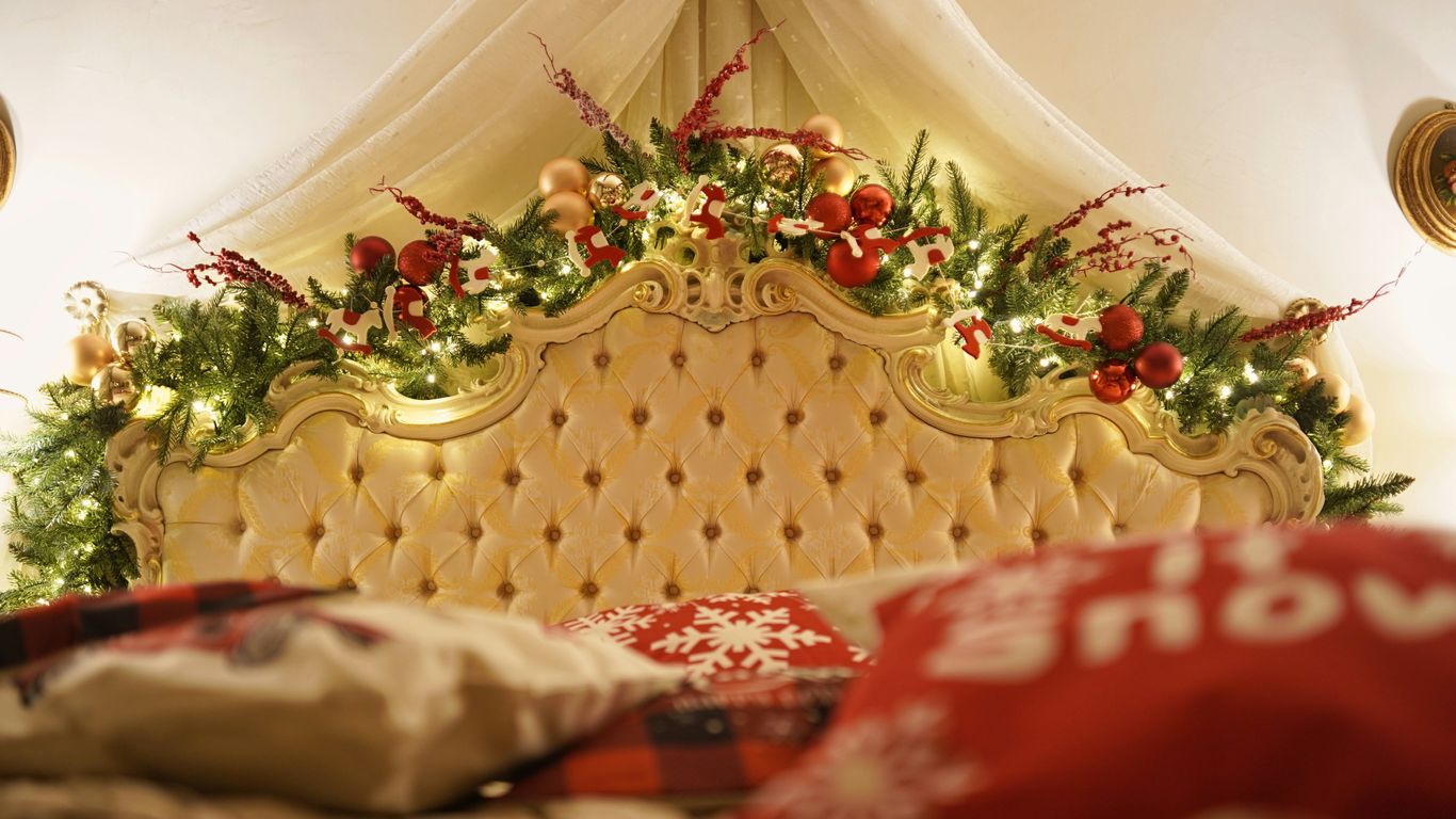 a bed with a canopy and christmas decorations on top of it